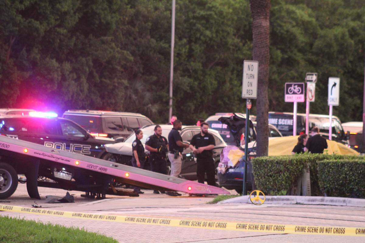 Crime scene investigators stand near a crash between Tesla and an SUV in North Miami Beach Wednesday, Oct. 1, 2025. One person was killed in the crash, and another person was hospitalized, police and firefighters said.