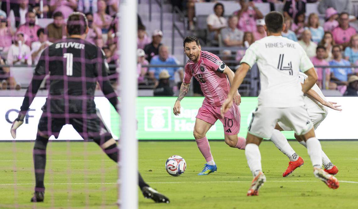 Inter Miami CF forward Lionel Messi (10) runs with the ball as Austin FC goalkeeper Brad Stuver (1) and defender Brendan Hines-Ike (4) defend in the first half of their MLS match at Nu Stadium in Miami Freedom Park on Saturday, April 4, 2026, in Miami, Fla.