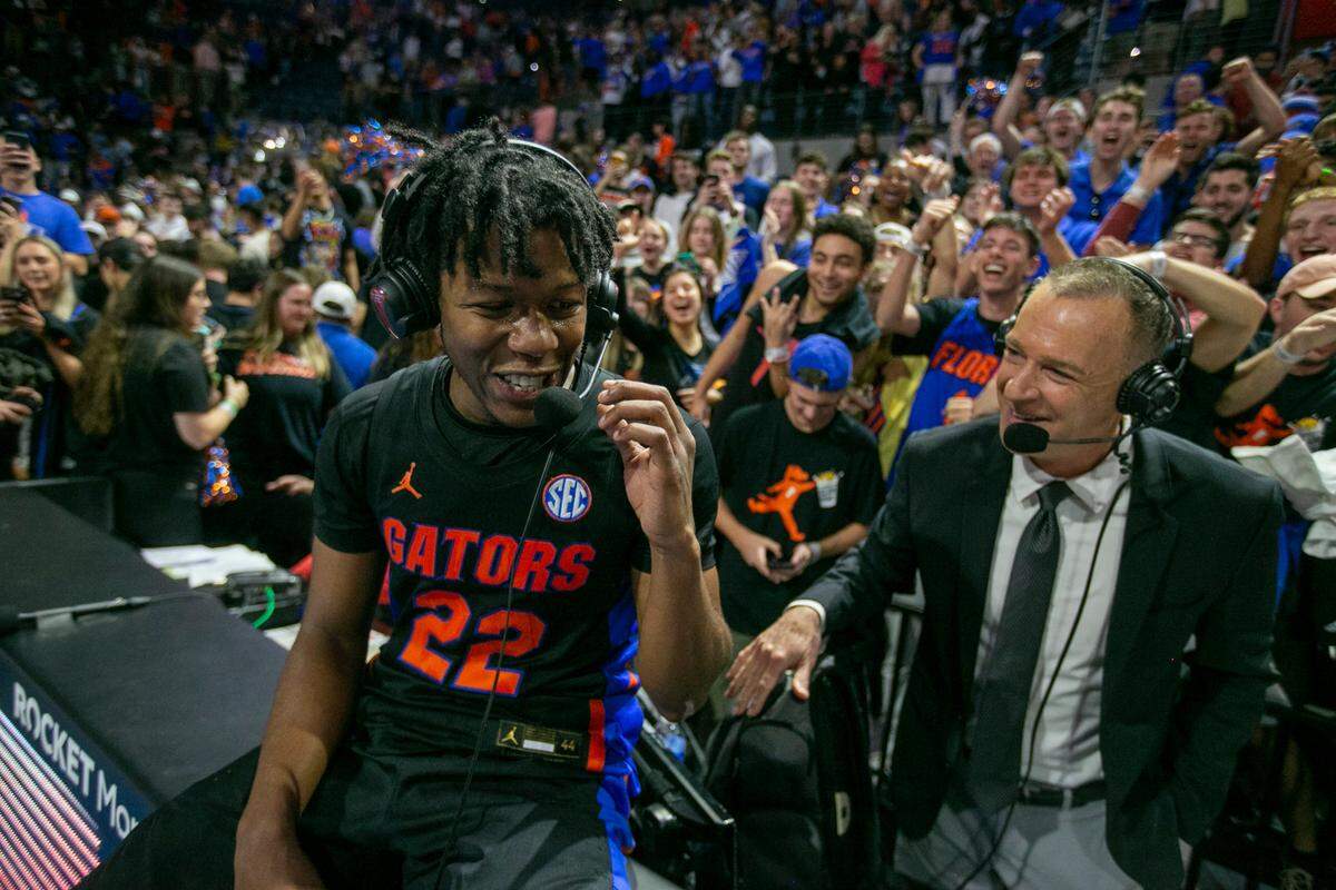 Florida guard Tyree Appleby (22), left, talks with broadcasters as he celebrates Florida’s 63-62 win over Auburn during an NCAA college basketball game Saturday, Feb. 19, 2022, in Gainesville, Fla.