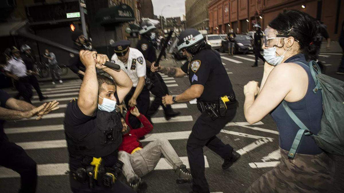 New York police officers with batons beat demonstrators protesting the death of George Floyd on May 30, 2020.