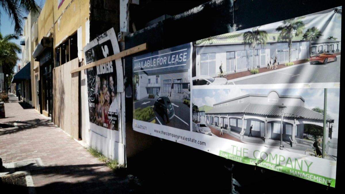 A sign at a small strip mall in Little Havana illustrates new construction planned for the site. Current tenants have been forced out due to increased rental rates. Owners of LeKoke Wine and Bites say they are struggling to keep their doors open.
