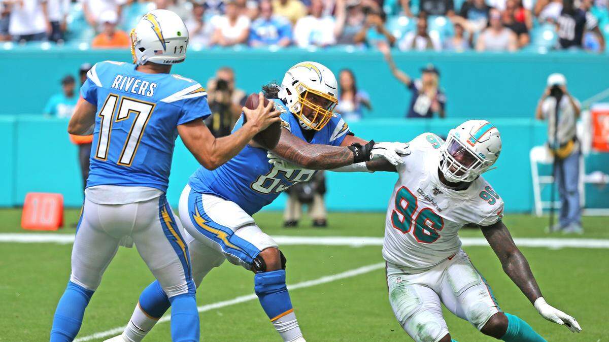 Miami Dolphins defensive end Taco Charlton (96) rushes LA Chargers quarterback Philip Rivers (17) as he is blocked by Sam Tevi (96) in the fourth quarter at Hard Rock Stadium in Miami Gardens, Florida, Sunday, September, 29, 2019.