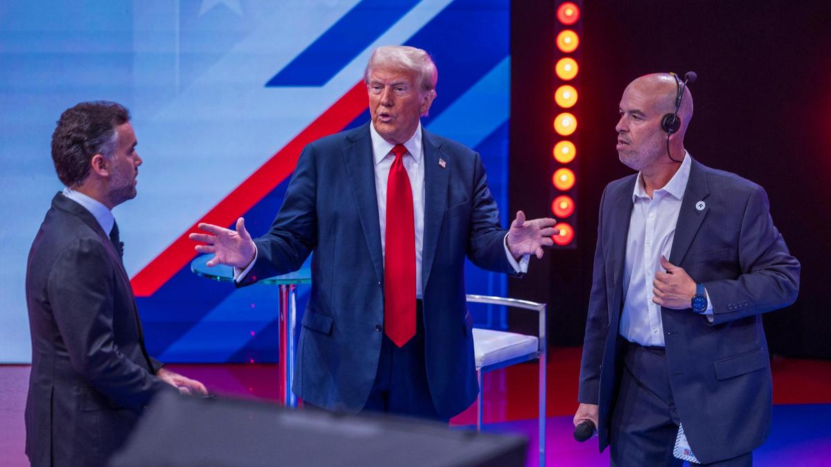 Republican nominee former President Donald Trump talks to moderator Enrique Acevedo (left) and Armando “Mandy” Castro, Technical Production Coordinator , during a Noticias Univision’s Town Hall, “Los Latinos Preguntan” at Univision studios in Doral, on Wednesday, October 16, 2024.