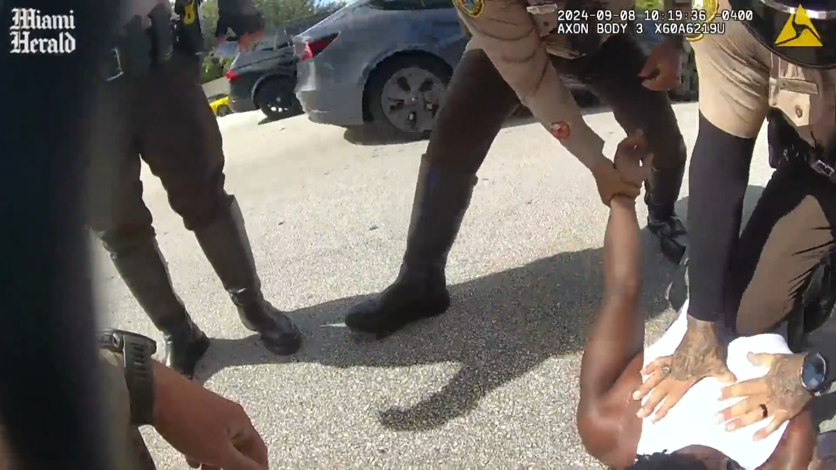 After yanking Miami Dolphins star receiver Tyreek Hill from his car, Miami-Dade police officers, as seen in police body-cam footage, pin him to the ground, put a knee in his back and handcuff him in a traffic stop last Sunday, Sept. 8, 2024, near Hard Rock Stadium. The incident occurred hours before the Dolphins were to play their season opener against the Jacksonville Jaguars.