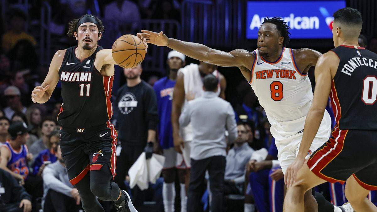 Miami Heat guard Jaime Jaquez Jr. (11) and New York Knicks forward/guard OG Anunoby (8) chase a loose ball during the first half of their NBA basketball game at Kaseya Center in Miami on October 26, 2025. 