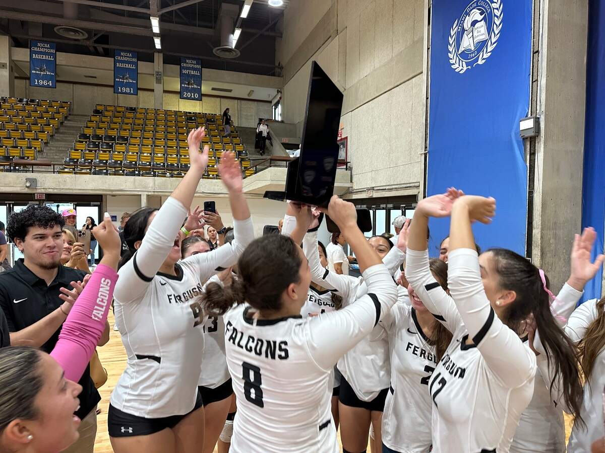 Ferguson’s girls’ volleyball players celebrate after winning the GMAC championship on Saturday at Miami Dade College’s Kendall campus gym.