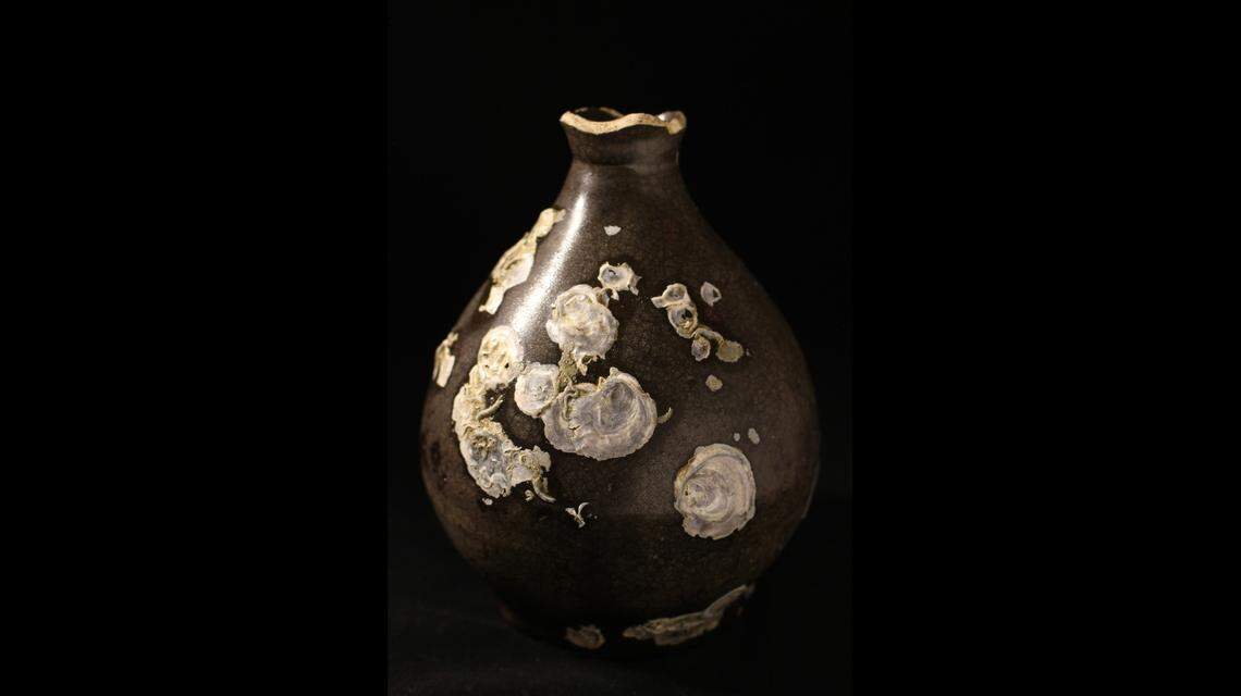 This delicate vase was made in Asia and shipped to Mexico as part of a trade route to Spain. It likely held spirits.