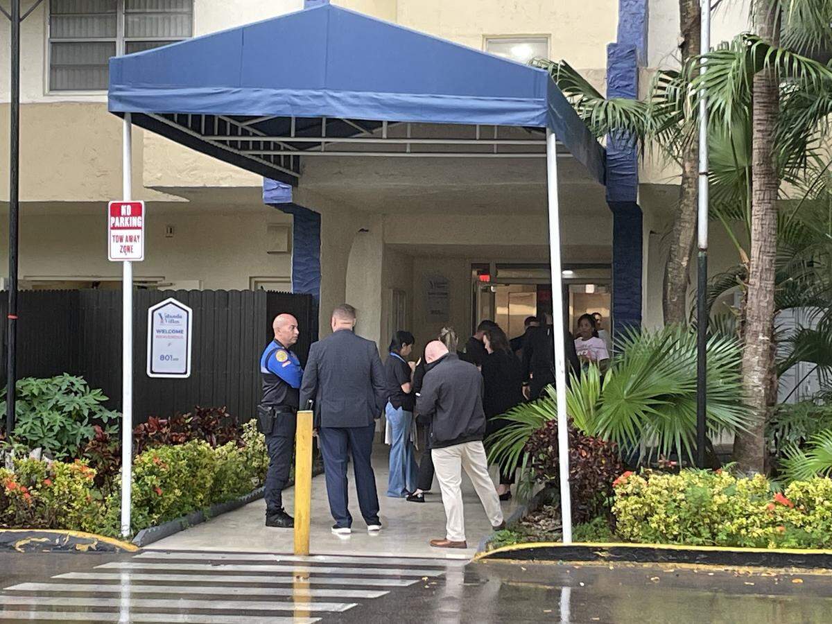 Miami police and others gather at a Flagami apartment complex where detectives say a man shot and killed his ex and her daughter on Wednesday, Dec. 13, 2023.