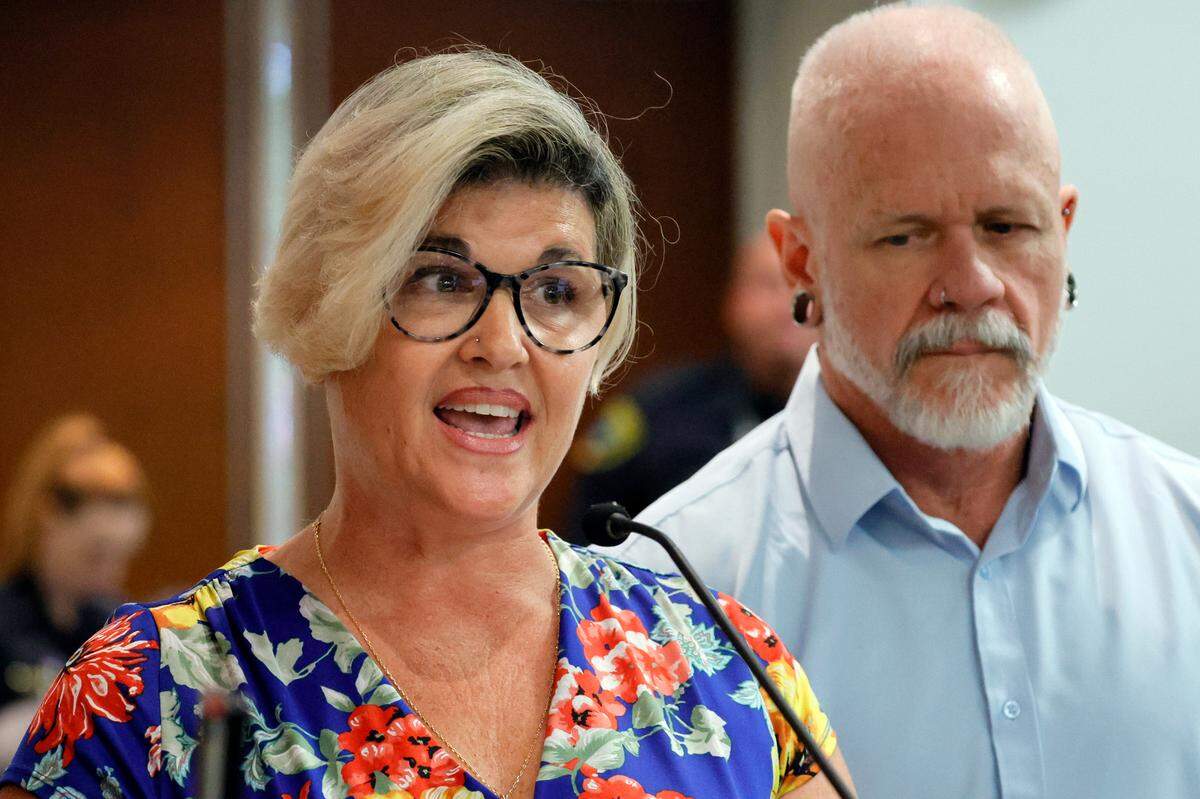 Jessica Norton, with her husband, Gary, speaks during the public comment period at a Broward County School Board meeting in Fort Lauderdale held on Tuesday, June 18, 2024. Norton, whose daughter played on the Monarch High School volleyball team, was one of five Monarch officials removed from the school Nov. 27 amid an inquiry into possible violations of the “Fairness in Women’s Sports Act,” a 2021 law that bans transgender girls from playing on girls’ sports teams. Norton is the only one facing potential discipline. (Amy Beth Bennett / Sun Sentinel)