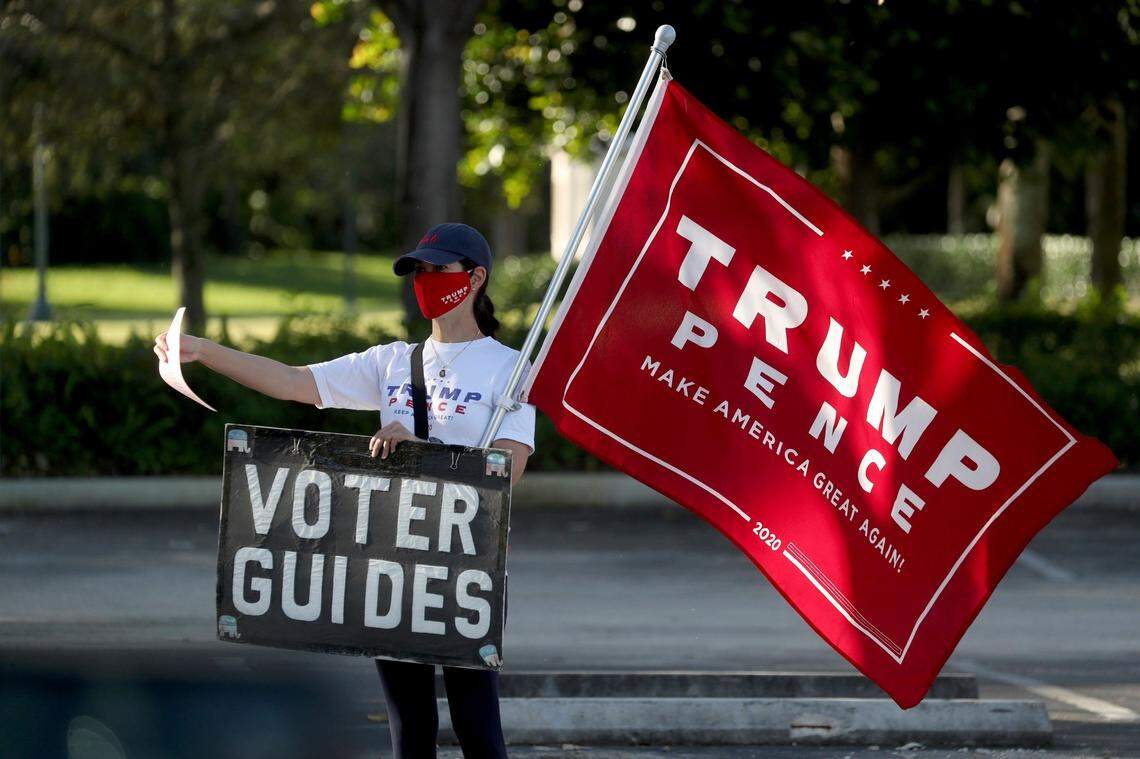 A Trump supporter campaigns on Election Day at the Weston Branch Library on Tuesday, Nov. 3, 2020, in Weston, Florida.