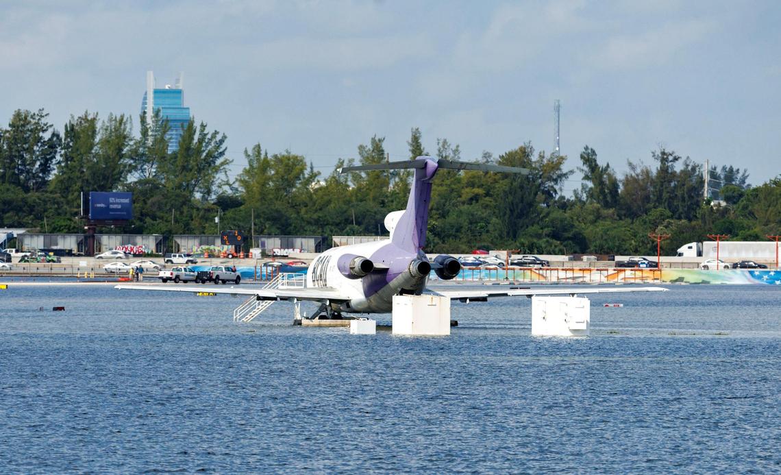 A BCAD Express airplane is parked as the runway remains flooded from heavy rain at Fort Lauderdale-Hollywood International Airport on Thursday, April 13, 2023.