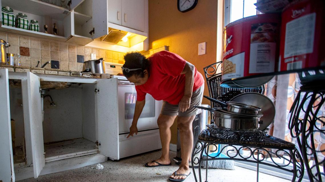 Nora Trujillo, 62, reacts to the water damage inside her kitchen caused by flooding that occurred a week earlier, in the Little Havana neighborhood of Miami, Florida, on Friday, June 10, 2022.