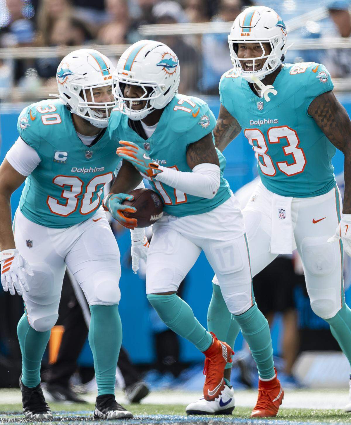 Miami Dolphins wide receiver Jaylen Waddle (17) celebrates with fullback Alec Ingold (30) and tight end Darren Waller (83) after scoring a touchdown against the Carolina Panthers in the second half of their NFL game at the Bank of America Stadium on Sunday, Oct. 5, 2025, in Charlotte, N.C.