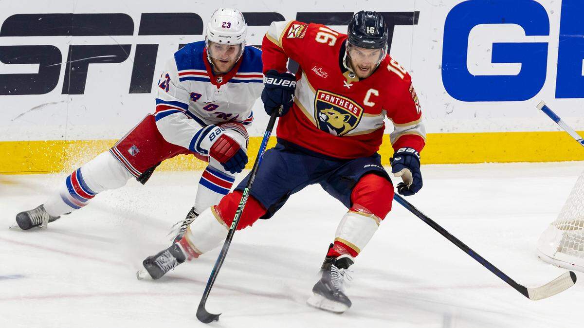 Florida Panthers center Aleksander Barkov (16) and New York Rangers defenseman Adam Fox (23) compete for the puck in the first period of Game 3 during the Eastern Conference finals of the NHL hockey Stanley Cup playoffs at the Amerant Bank Arena on Sunday, May 26, 2024, in Sunrise, Fla.