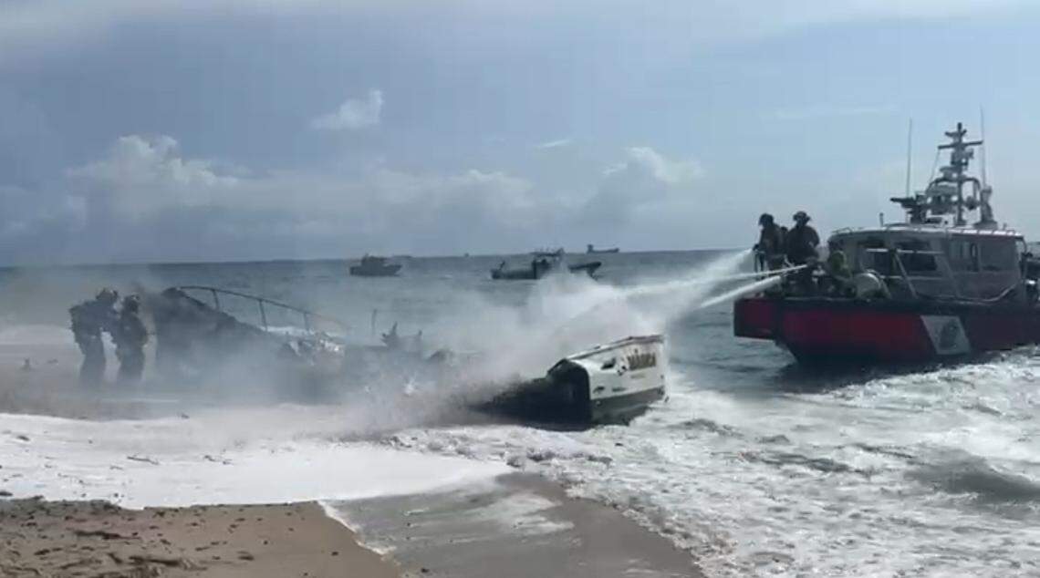 Firefighters spray down a burning 30-foot boat that went up in flames off the beach in Fort Lauderdale Wednesday, May 28, 2025.