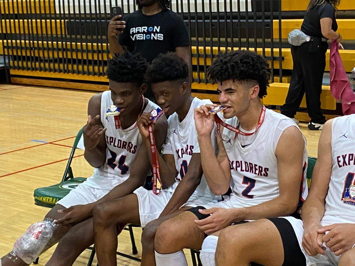From left to right, Columbus’ Malik Abdullahi, Michael Feenane and Cayden Boozer celebrate their victory over Norland in the GMAC boys’ championship game on Thursday night at Miami Jackson High.