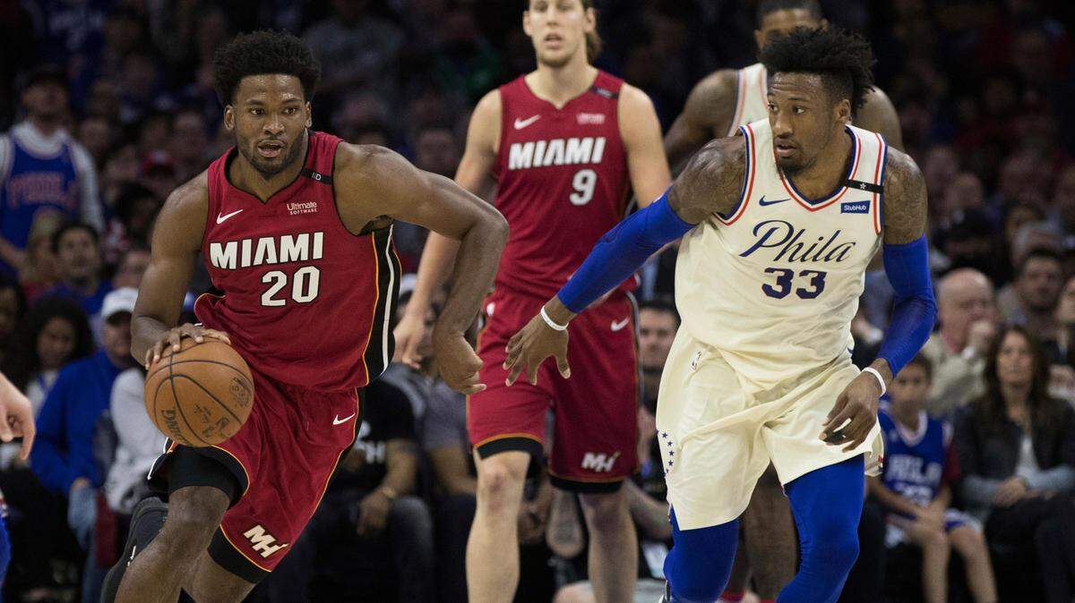 Miami Heat's Justise Winslow, left, drives up the court against Philadelphia 76ers' Robert Covington, right, during the first half in Game 5 of a first-round NBA playoff series, Tuesday, April 24, 2018, in Philadelphia.