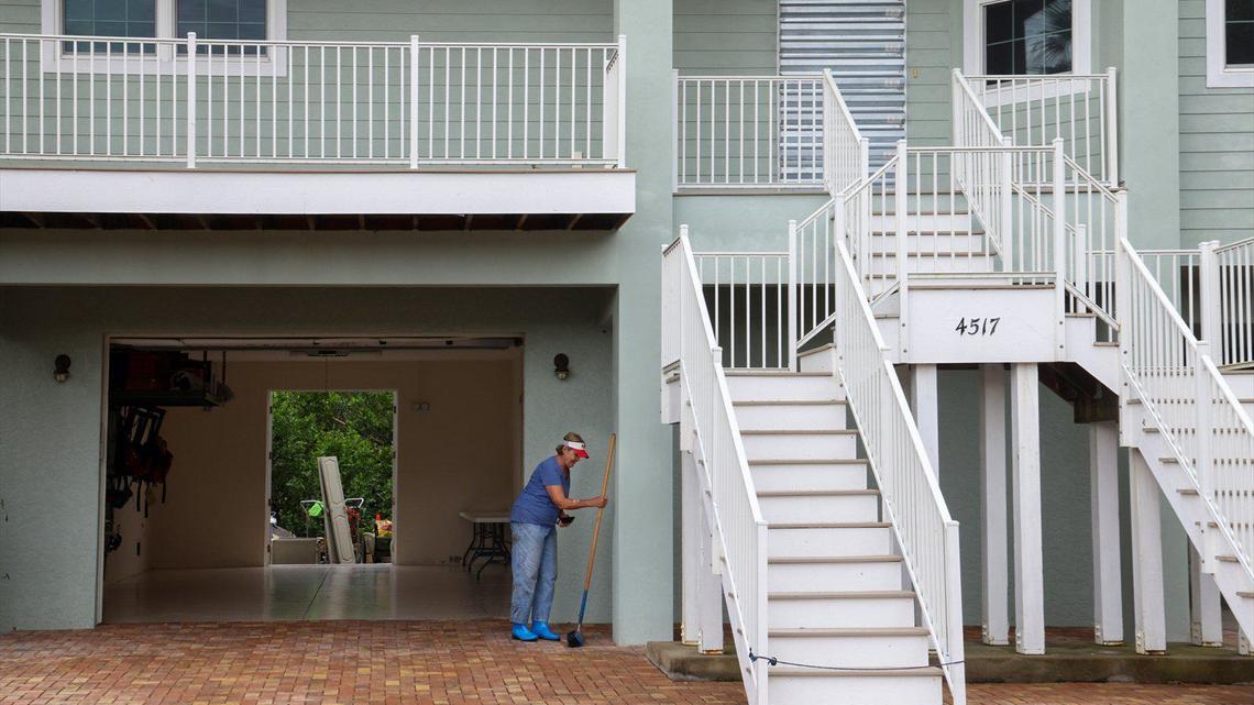 Hurricane Milton’s storm surge moved and damaged boats, cars, and devastated homes not built up to the new code. Marilyn Gladish, 83, leans a broom against the exterior of her two-level home after the removal of mud, debris, and damaged items from the ground floor with the help of her grandson on Friday, October 11, 2024, in Port Charlotte, Florida.