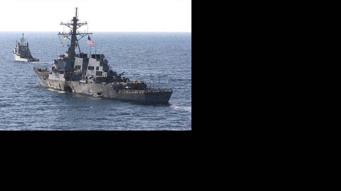 The USS Cole (DDG 67) is towed away from the port city of Aden, Yemen, into open sea by the Military Sealift Command ocean-going tug USNS Catawba (T-ATF 168) on Oct. 29, 2000.