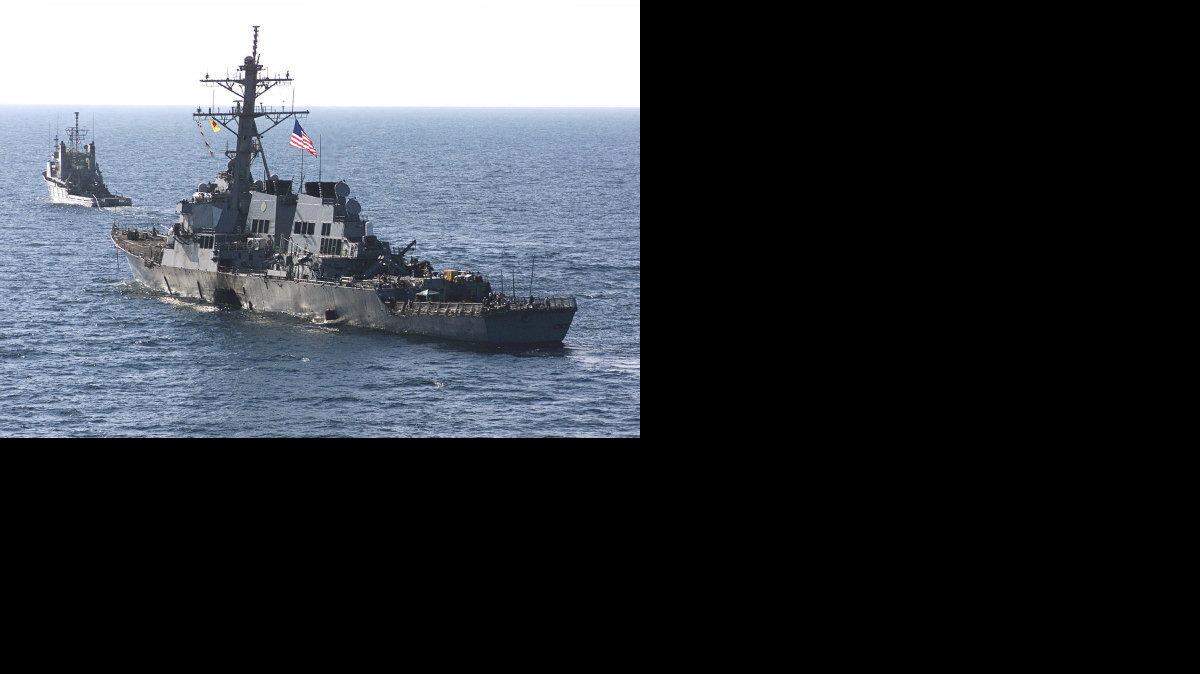 The USS Cole (DDG 67) is towed away from the port city of Aden, Yemen, into open sea by the Military Sealift Command ocean-going tug USNS Catawba (T-ATF 168) on Oct. 29, 2000.