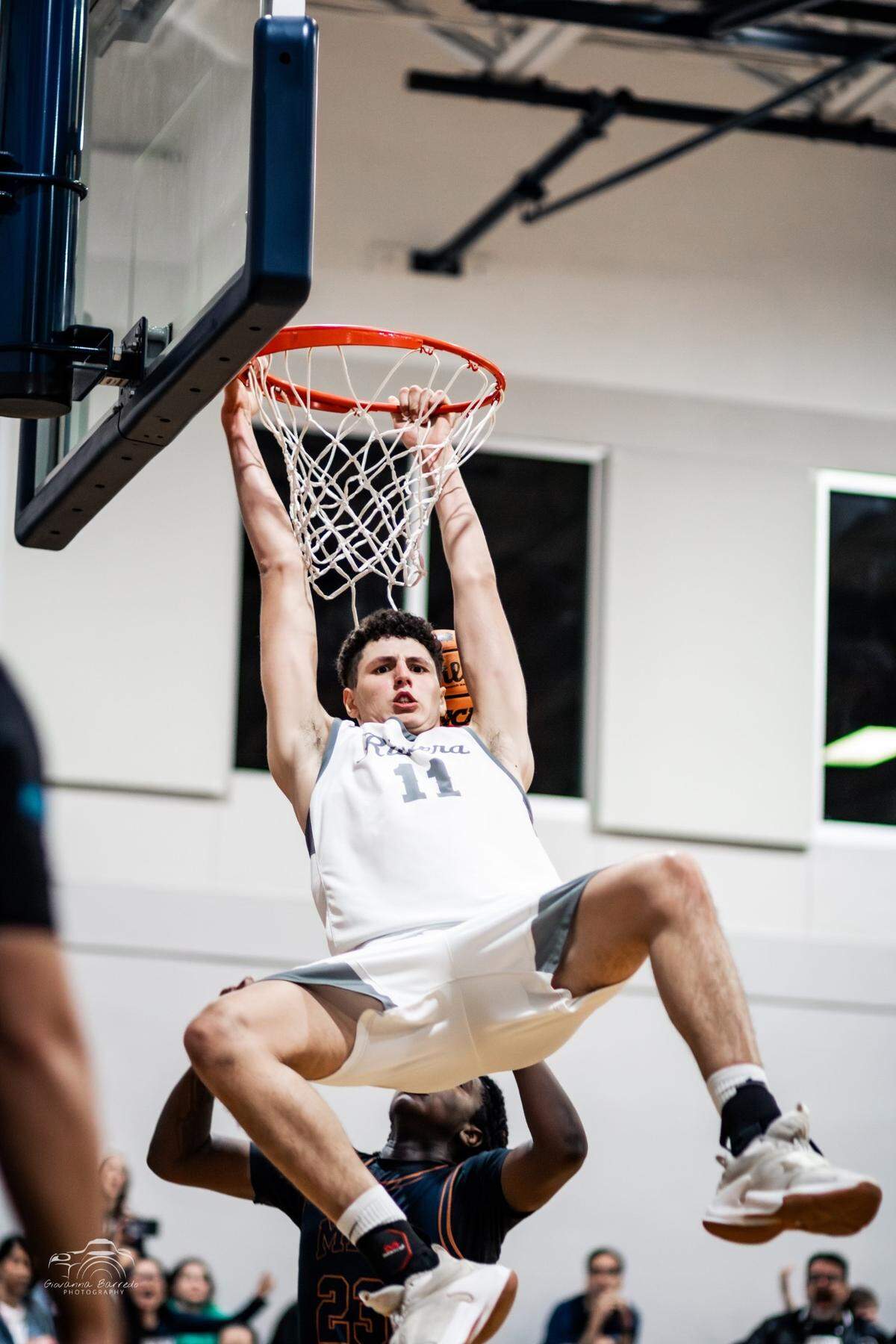 Riviera Prep forward Gustavo Guimaraes Alves dunks during the Bulldogs’ 63-49 win over Mater Lakes on Monday night at Riviera Prep.
