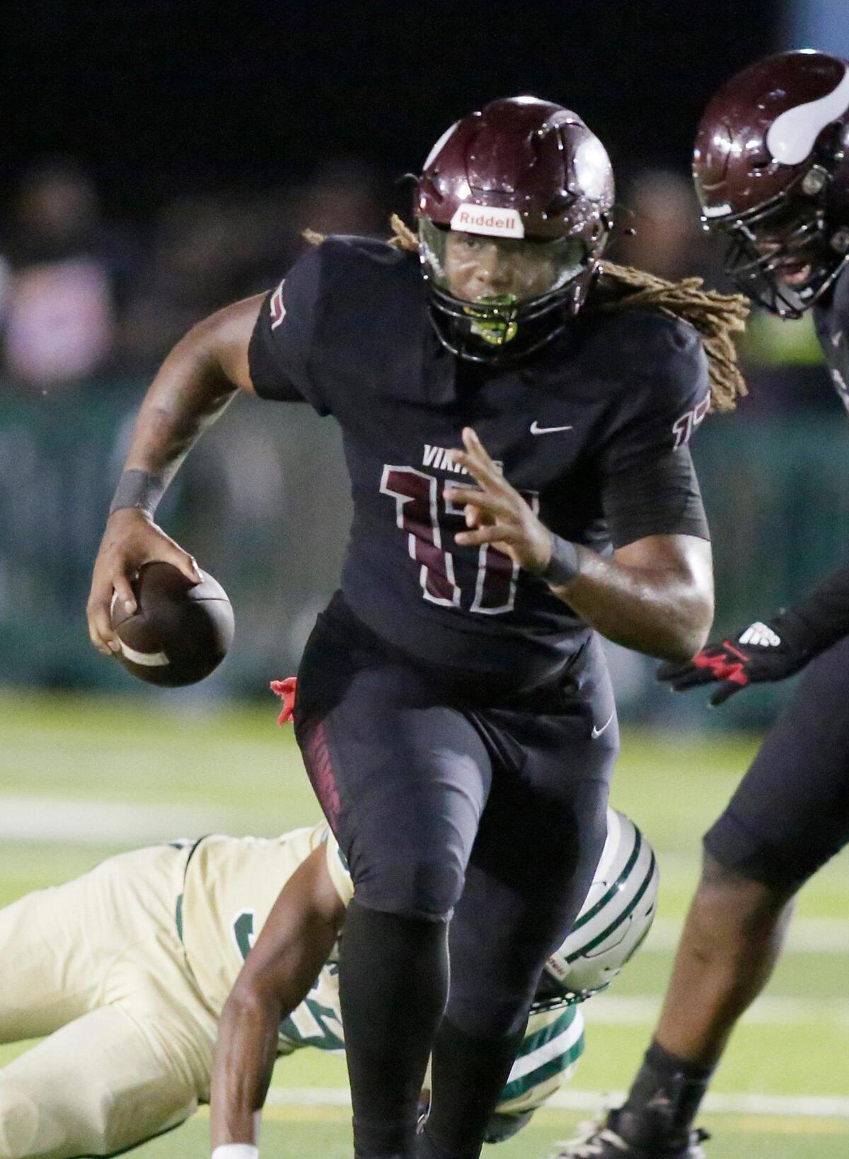 Norland Vikings quarterback Enio Yapoor Jr. (17) runs the ball against Miami Central Rockets during the regional final playoff football game on Friday, November 23, 2023 at Traz Powell Stadium in Miami. Andrew Uloza / for Miami Herald