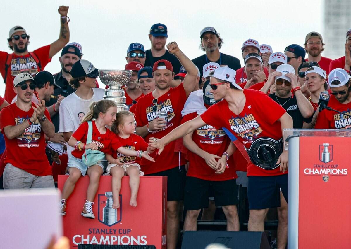 Florida Panthers left wing Matthew Tkachuk celebrates with teammates and family members on stage during the team’s Stanley Cup victory parade and rally along A1A in Fort Lauderdale, Florida, on Sunday, June 22, 2025.