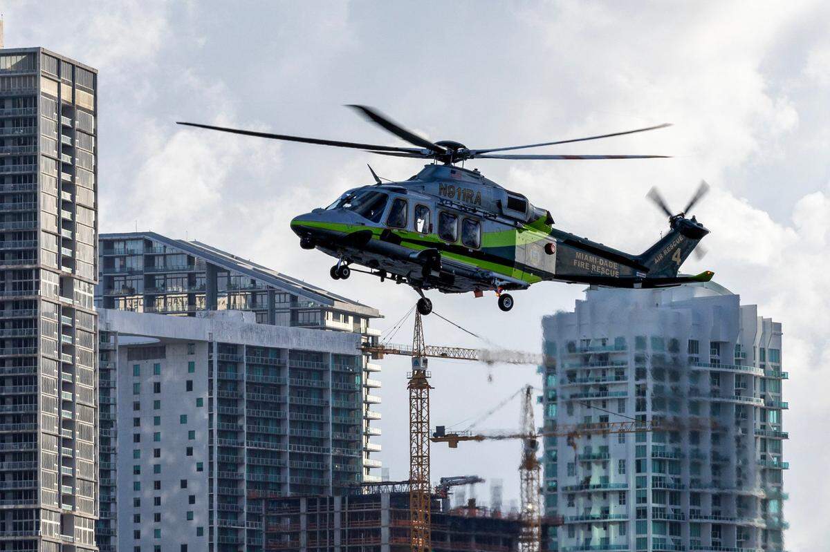 A Miami-Dade Fire-Rescue helicopter approaches a boat to perform a rescue during a South Florida Public Safety Regional Assets in Action Demonstration showcasing an active threat response incident in Biscayne Bay as part of the annual 2024 National Homeland Security Conference at PortMiami, Terminal J on Wednesday, July 24, 2024, in Miami, Fla.