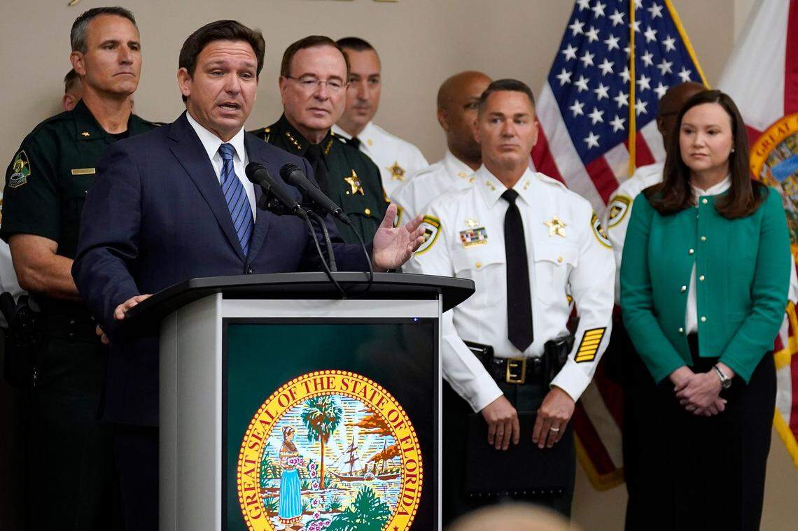 Florida Gov. Ron DeSantis, surrounded by members of law enforcement, gestures as he speaks during a news conference Thursday, Aug. 4, 2022, in Tampa, Florida. DeSantis announced that he was suspending State Attorney Andrew Warren.