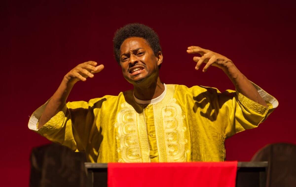 Isaac Beverly preaches the pain-filled story of the crucifixion in M Ensemble’s “God’s Trombones.”