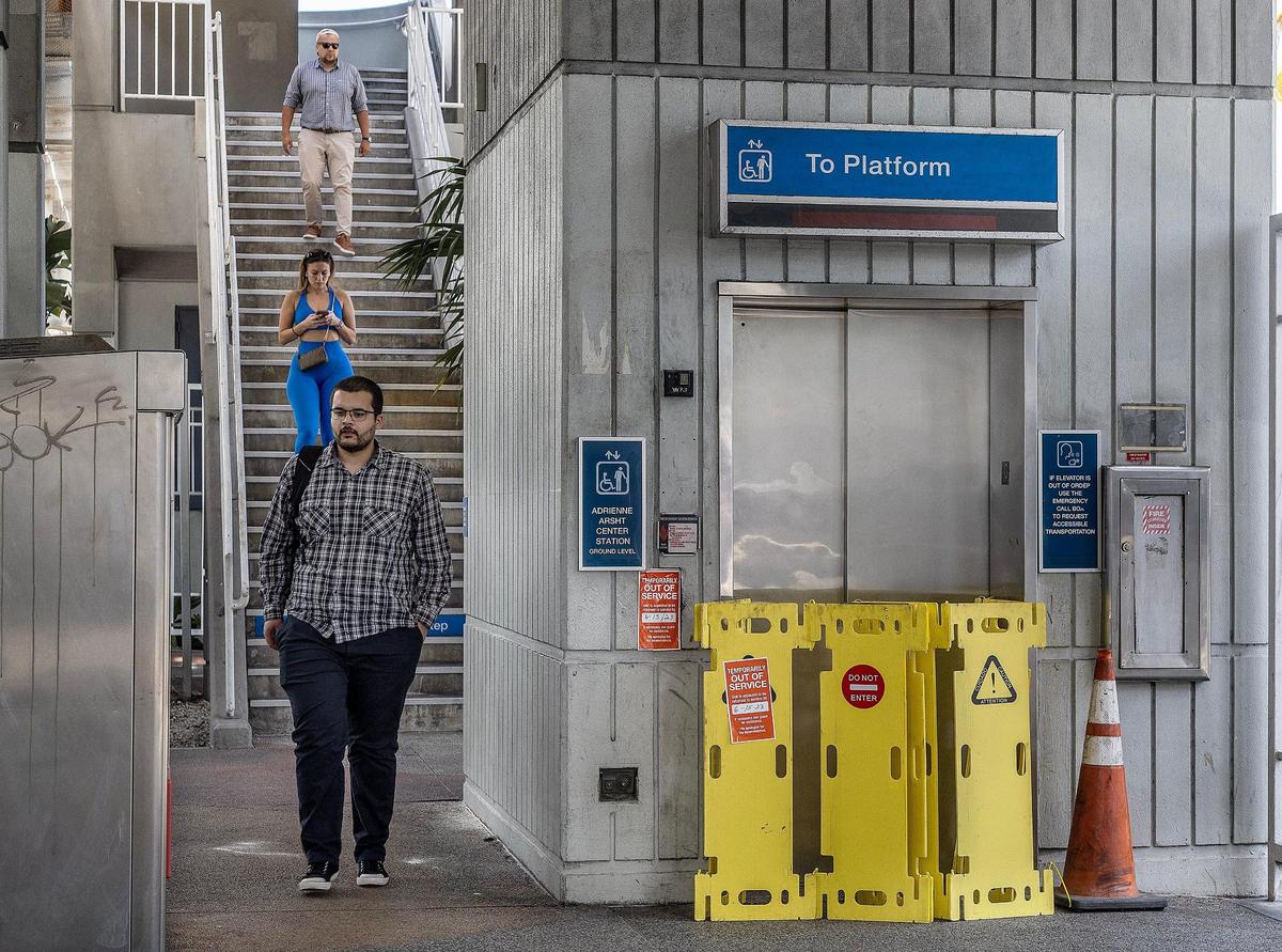 Metromover users are forced to walk down the stairs another day on at the Adrienne Arsht Center Station in Miami with the elevator and escalator broken. Up for weeks, the repair signs remained on Tuesday, May 16, 2023.