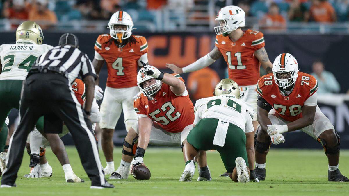 Miami Hurricanes offensive lineman James Brockermeyer (52) gestures at the line of scrimmage in the second half during the NCAA football game against the South Florida Bulls at Hard Rock Stadium in Miami Gardens, Florida, on Saturday, September 13, 2025.