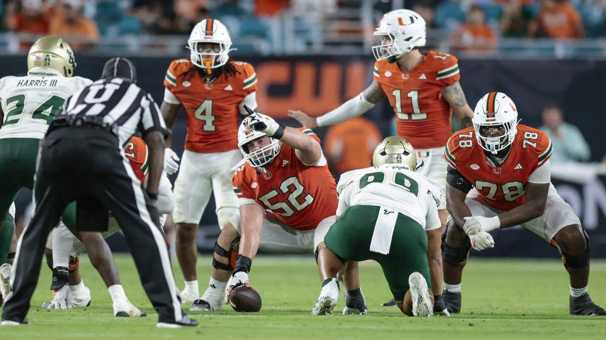 Miami Hurricanes offensive lineman James Brockermeyer (52) gestures at the line of scrimmage in the second half during the NCAA football game against the South Florida Bulls at Hard Rock Stadium in Miami Gardens, Florida, on Saturday, September 13, 2025.