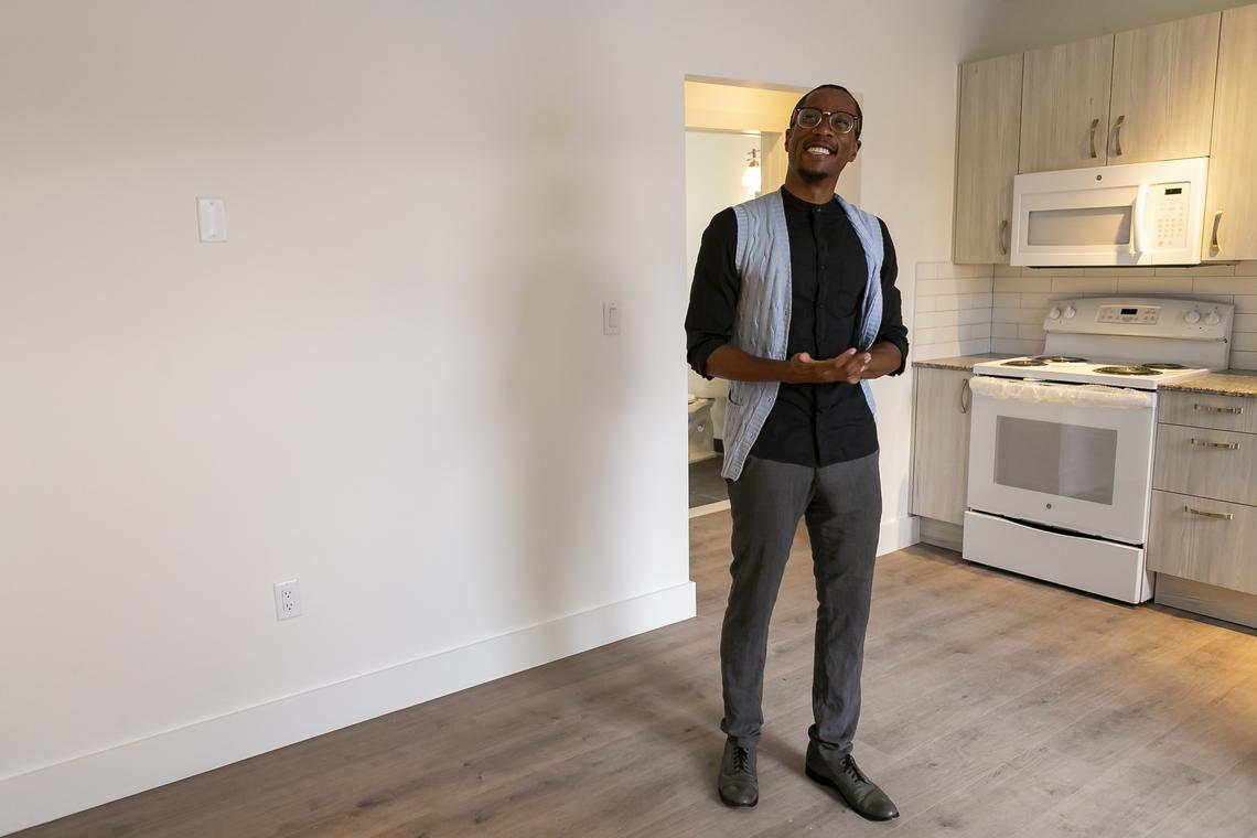Resident Joseph Akharoh looks through a renovated apartment during the “Move-In Celebration” at the 16 Corner project in Overtown.