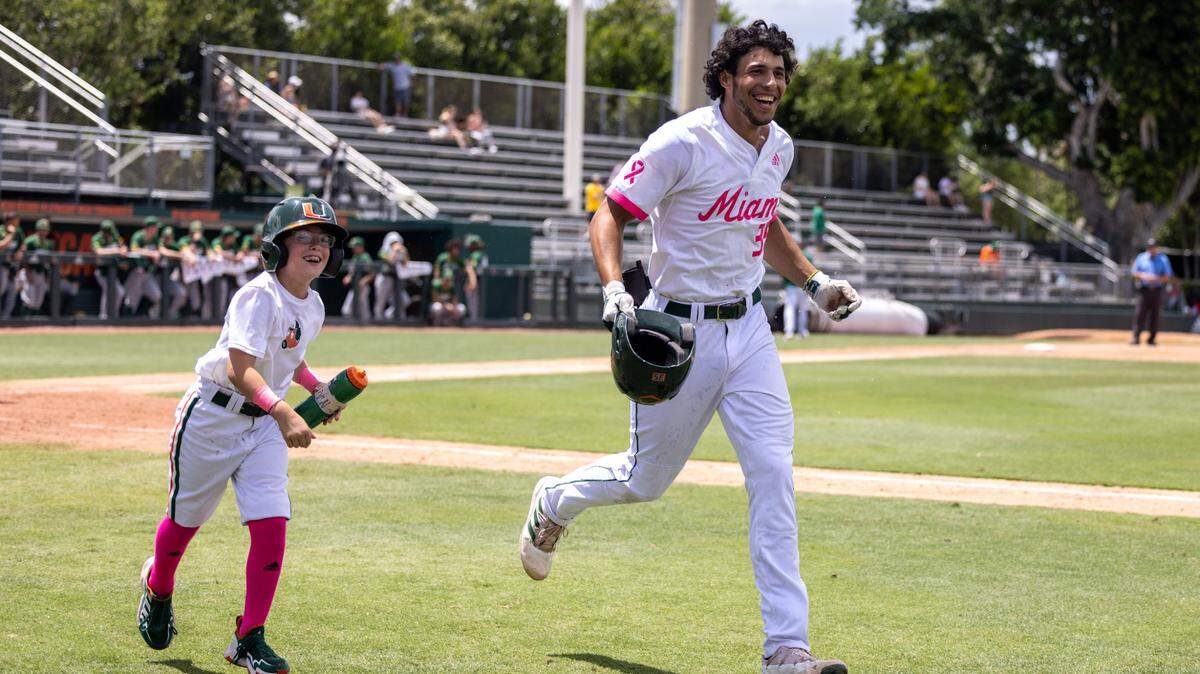 Yohandy Morales is all smiles after hitting a home run for UM against North Dakota State on Sunday, May 8, 2022. With him is Miami batboy Kam Clute.