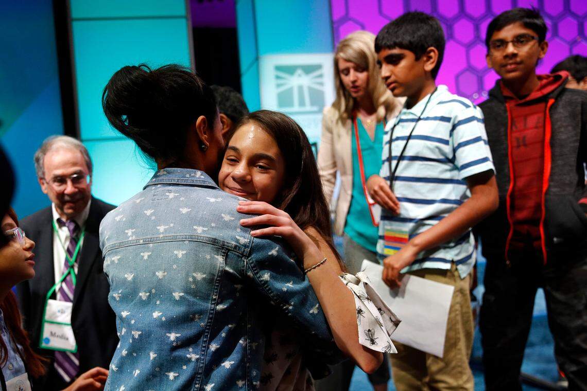 Simone Kaplan, 13, of Davie, hugs her mother Alana as she walks offstage after reaching the final round of the Scripps National Spelling Bee, Thursday, May 30, 2019, in Oxon Hill, Md.