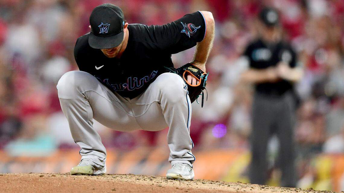 Anthony Bender #80 of the Miami Marlins kneels on the mound after loading the bases in the sixth inning during their game against the Cincinnati Reds at Great American Ball Park on August 21, 2021 in Cincinnati, Ohio.