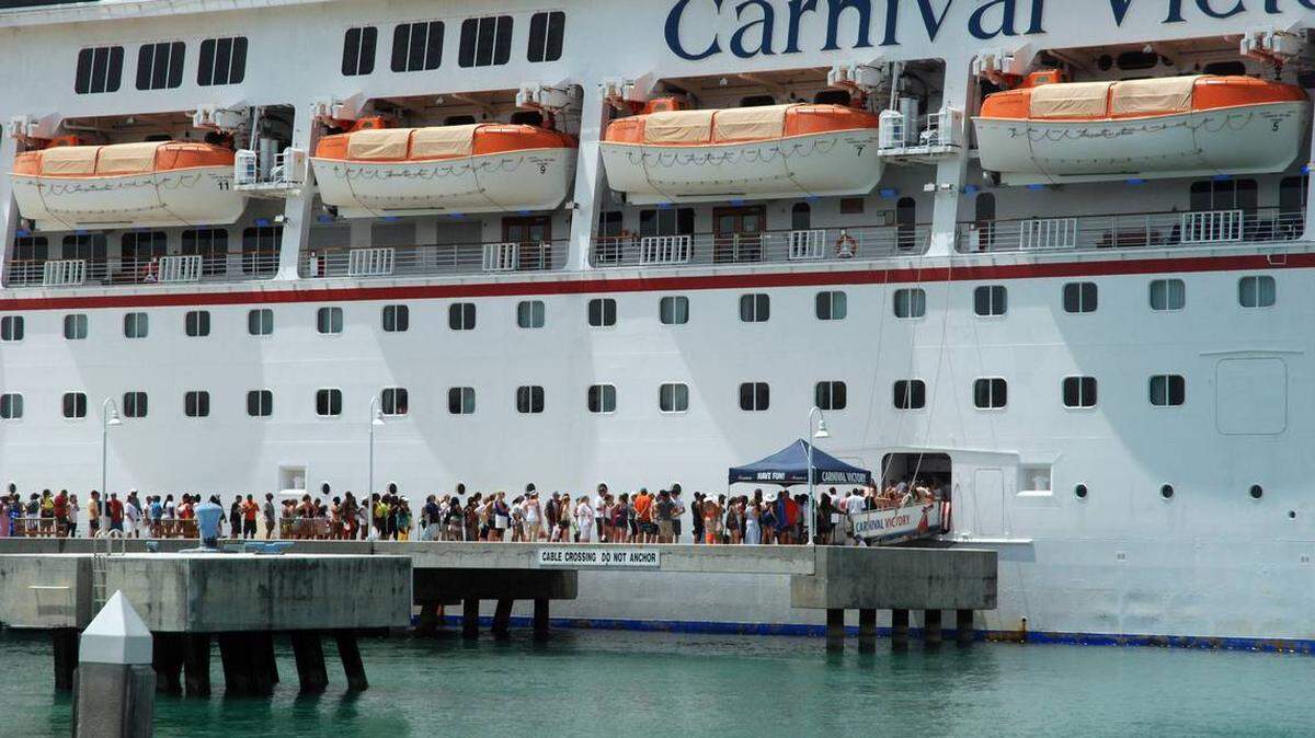 Passengers return to the Carnival Victory cruise ship after a past stop in Key West.
