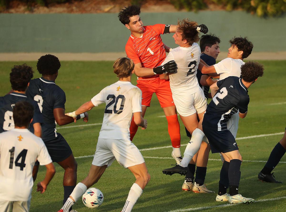 NSU goalkeeper Nikolas Ricardo (1) leaps beside Trinity Prep player Mason Dowdy (2) during the FHSAA Class 3A state championship game of Trinity Prep versus NSU University School at Spec Martin Stadium in DeLand on Thursday, February 23, 2023. Trinity Prep won won the match on overtime penalty kicks to claim the state championship. (Stephen M. Dowell/Orlando Sentinel)