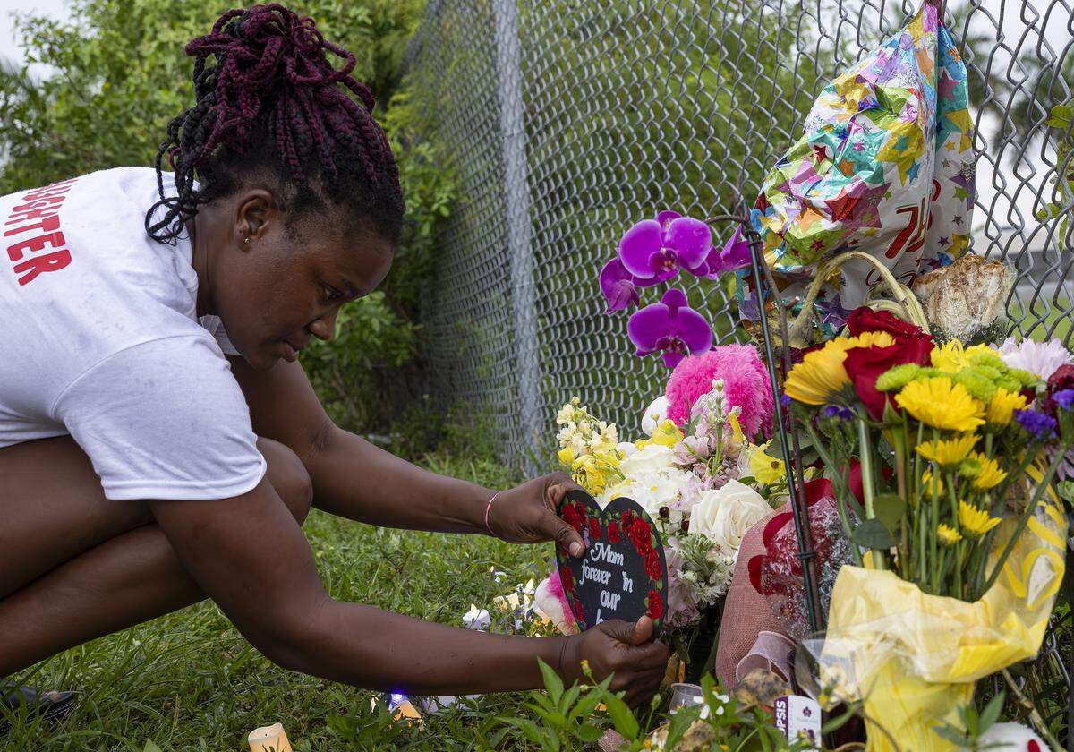 Lateisha Wilkinson arranges a makeshift memorial for her mother, Doreen Richards Broadbelt, 71, who police said was walking to her job at Walmart when a dog attacked and fatally mauled her near her home on Labor Day. A vigil was held nearby at Broadbelt's home on Tuesday, Sept. 9, 2025, in Miami Gardens, Fla.