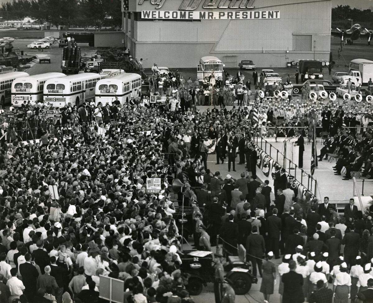 President John F. Kennedy at Miami International Airport on Nov. 18, 1963, where 4,000 people greeted the president. Kennedy is on the raised platform.