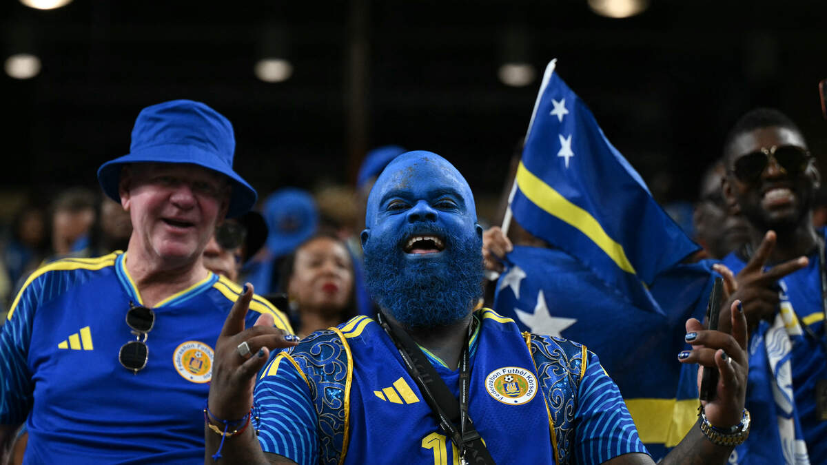 TOPSHOT - Curacao supporters pose prior to the  2026 World Cup Group E football match between Germany and Curacao at the Houston Stadium in Houston on June 14, 2026.  (Photo by RONALDO SCHEMIDT / AFP via Getty Images)