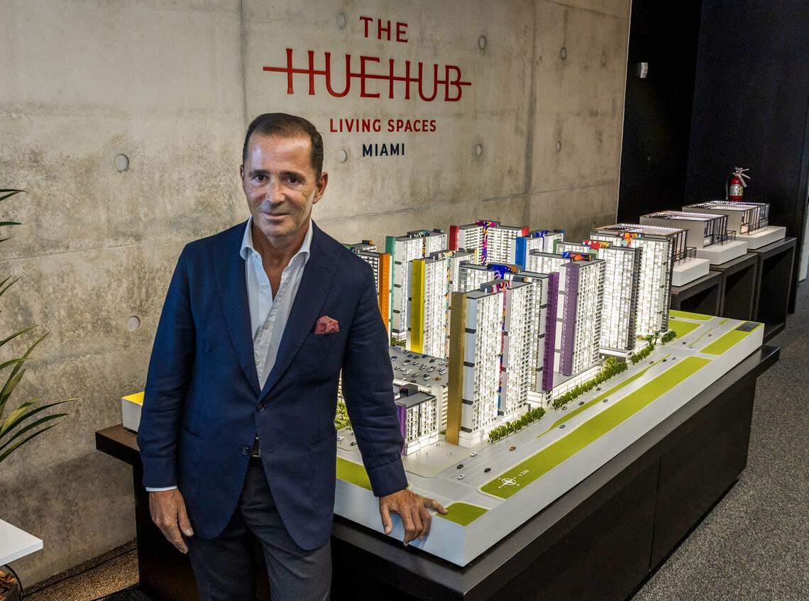 Developer Pablo Castro poses next to a scale model of his $880 million HueHub development, which will bring 4,000 apartments to Miami-Dade County’s West Little River area. Castro is setting aside 3,000 apartments at unusually low rents for first responders and teachers.