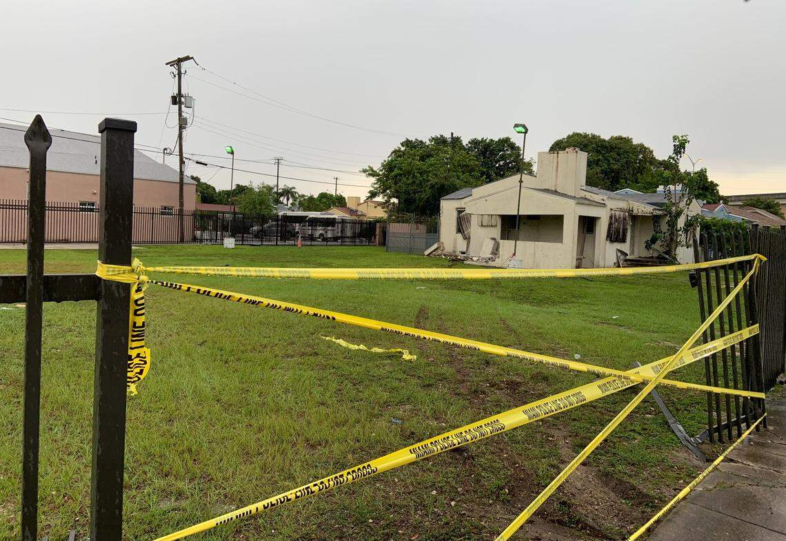 Crime scene tape covers the opening in the fence at 677 NW 47th St. created when a BMW SUV smashed through it Tuesday morning.