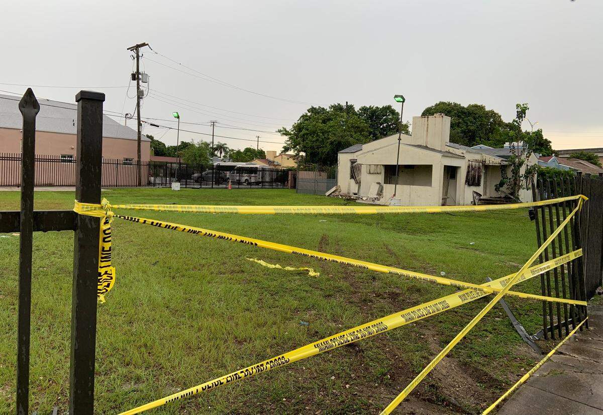 Crime scene tape covers the opening in the fence at 677 NW 47th St. created when a BMW SUV smashed through it Tuesday morning.