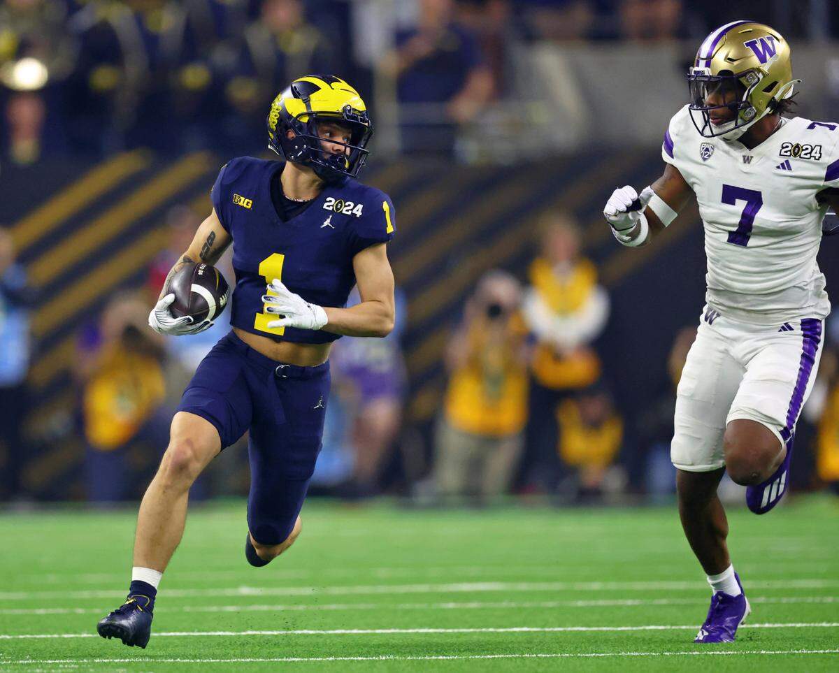 Jan 8, 2024; Houston, TX, USA; Michigan Wolverines wide receiver Roman Wilson (1) runs with the ball against the Washington Huskies during the first quarter in the 2024 College Football Playoff national championship game at NRG Stadium. Mandatory Credit: Mark J. Rebilas-USA TODAY Sports