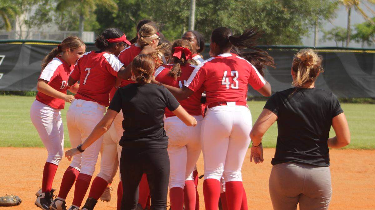 Coral Gables players mob each other at the center of the field following the final out of Friday afternoon’s 6-2 victory over Coral Reef in a Region 4-9A final at Reef High School as the team clinched a first ever trip to the state final four.