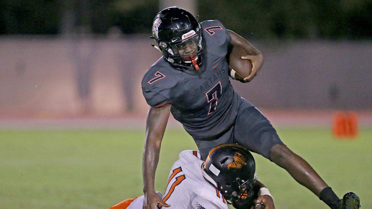 Booker T Washington’s Eddie Jackson (11) tackles Southridge’s Tyrique Stevenson (7) in a Sept. 6 game. Stevenson - being recruited as a cornerback - will announce on Wednesday whether he will attend UM or Georgia.