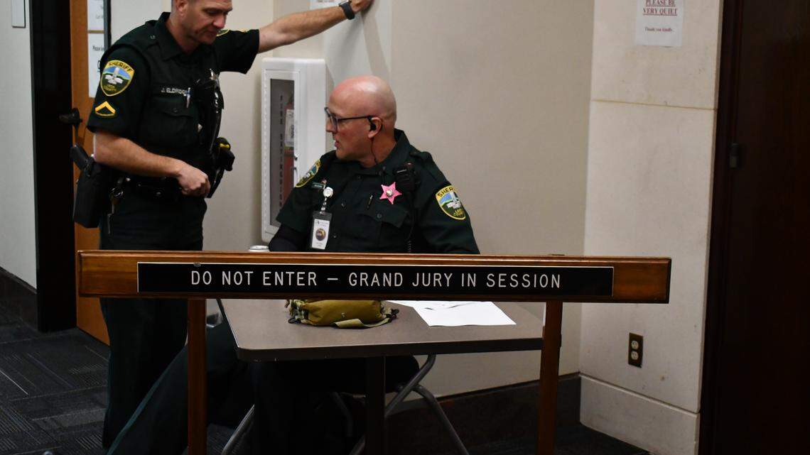 Two Leon County Sheriff’s Deputies guard the entrance to the courtroom where witnesses are testifying before a grand jury in the investigation related to Hope Florida.