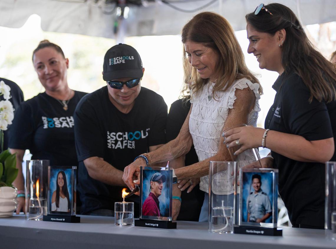 Linda Beigel Schulman, the mother of Scott Beigel, lights a candle in his honor during the ‘Forever in Our Hearts’ commemoration event outside of the Eagles’ Haven Wellness Center on Friday, Feb. 14, 2025, in Coral Springs, Fla. The event aims to honor the 17 lives lost during the Marjory Stoneman Douglas High School shooting in 2018 and their families.